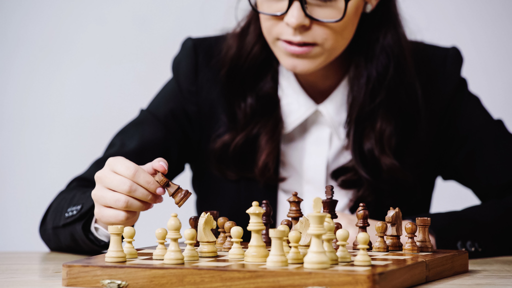 partial view of businesswoman playing chess isolated on grey - Фото, изображение