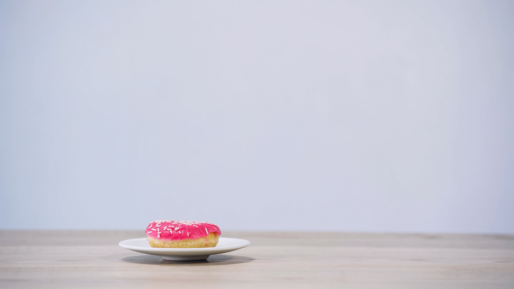 sweet glazed doughnut on plate isolated on grey - Photo, Image