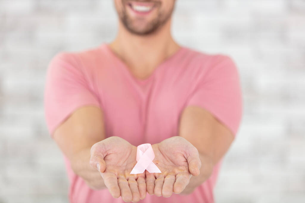 руки з рожевою стрічкою, що символізує боротьбу з раком молочної залози
 - Фото, зображення