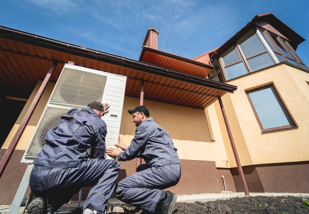 HVAC technicians servicing home heating and cooling system - Photo, Image
