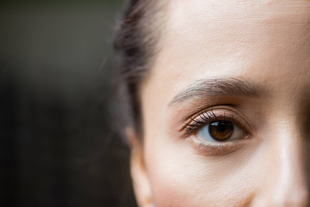 partial view of young woman looking at camera, eye care concept - Photo, image