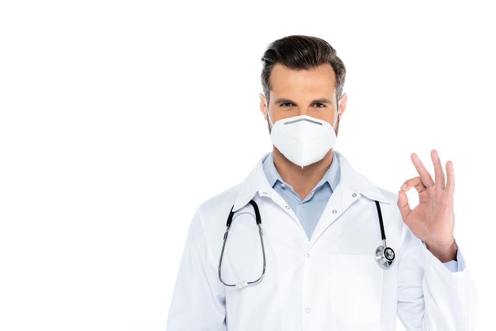 doctor in medical mask and white coat showing okay gesture isolated on white - Foto, Imagen