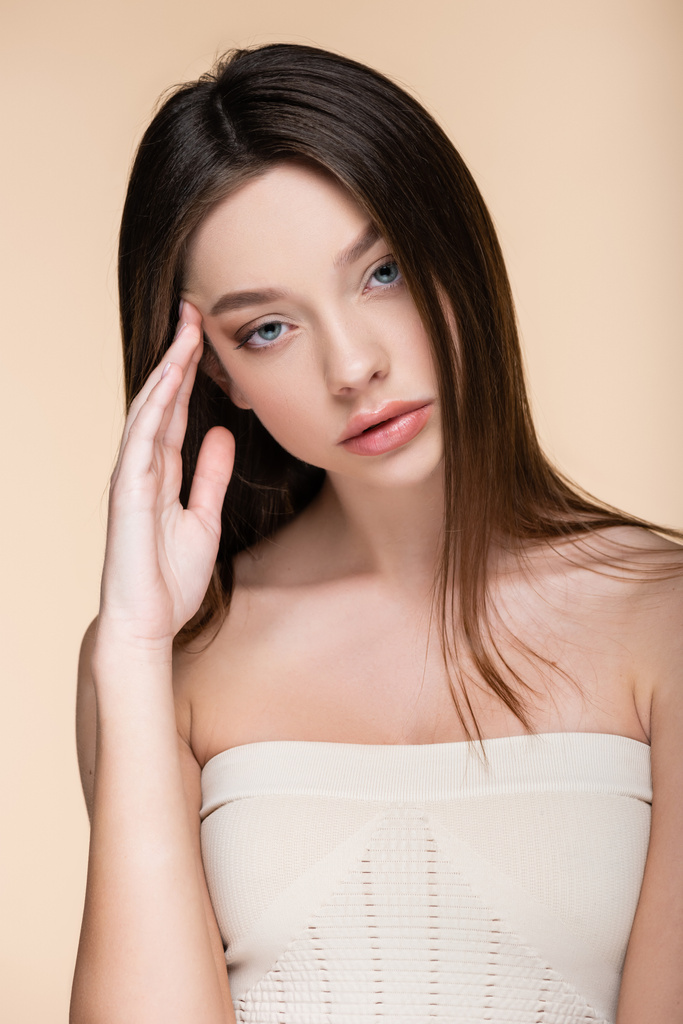 young model in crop top with bare shoulders isolated on beige - Photo, Image