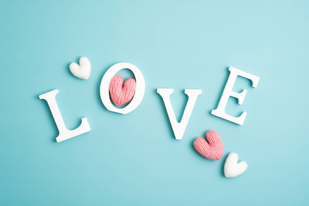 Happy Valentines Day concept. Word Love and hearts on pastel blue background. Flat lay, top view. - Valokuva, kuva