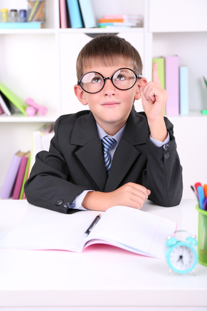 Schoolboy sitting at table in classroom - Photo, Image