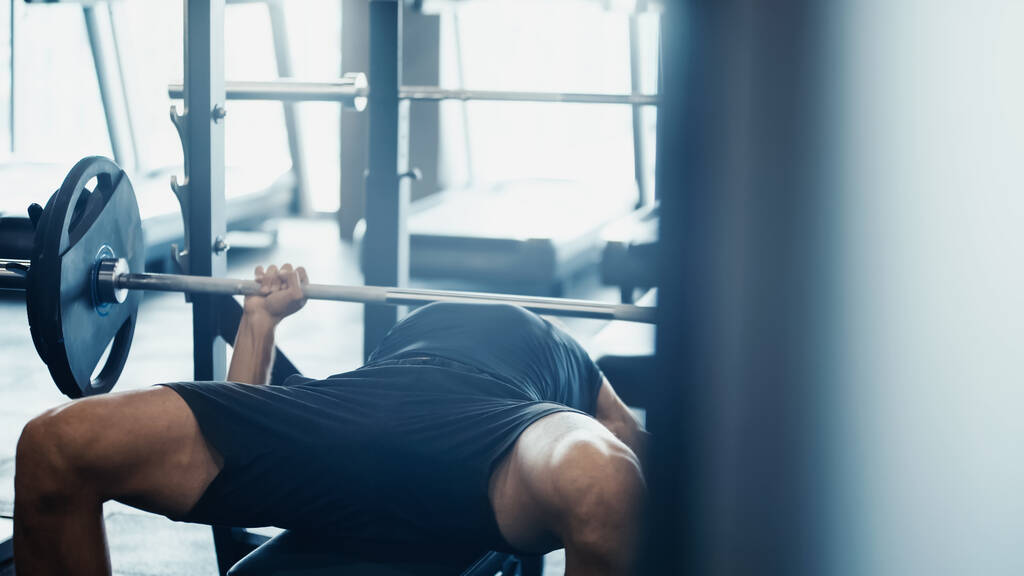 strong sportsman weightlifting barbell in gym  - Foto, Imagem