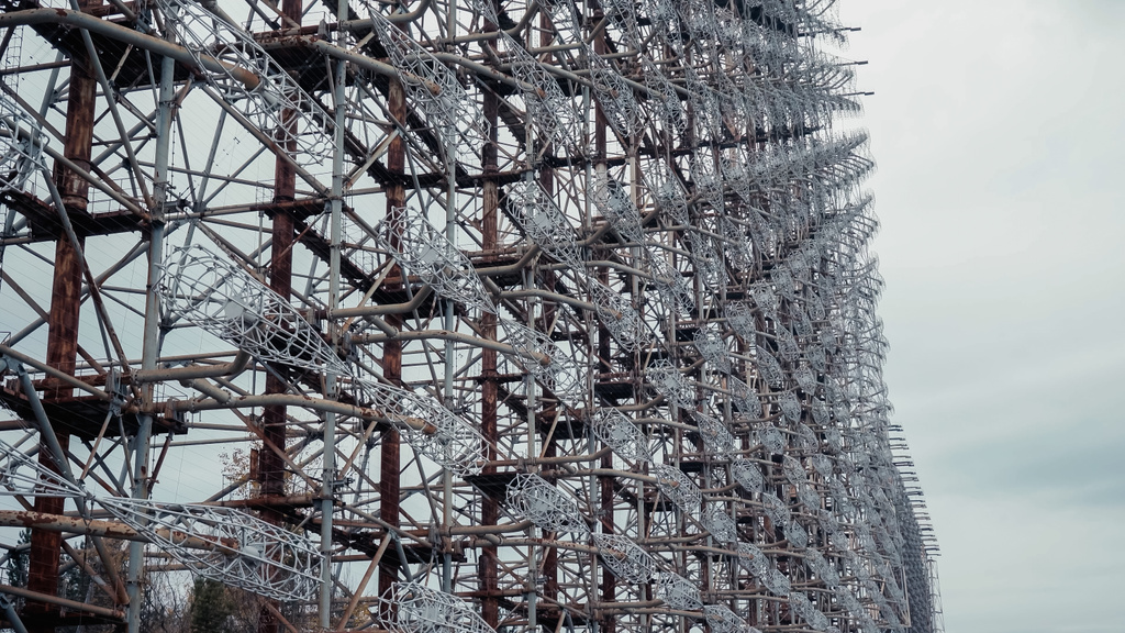 steel radar station in chernobyl exclusion zone under grey cloudy sky - Фото, изображение