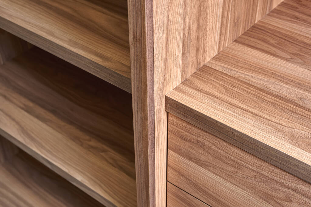 Elegant cabinet of walnut tree solid and veneer wood with empty shelves and drawers in walk-in closet in renovated apartment close-up - Zdjęcie, obraz
