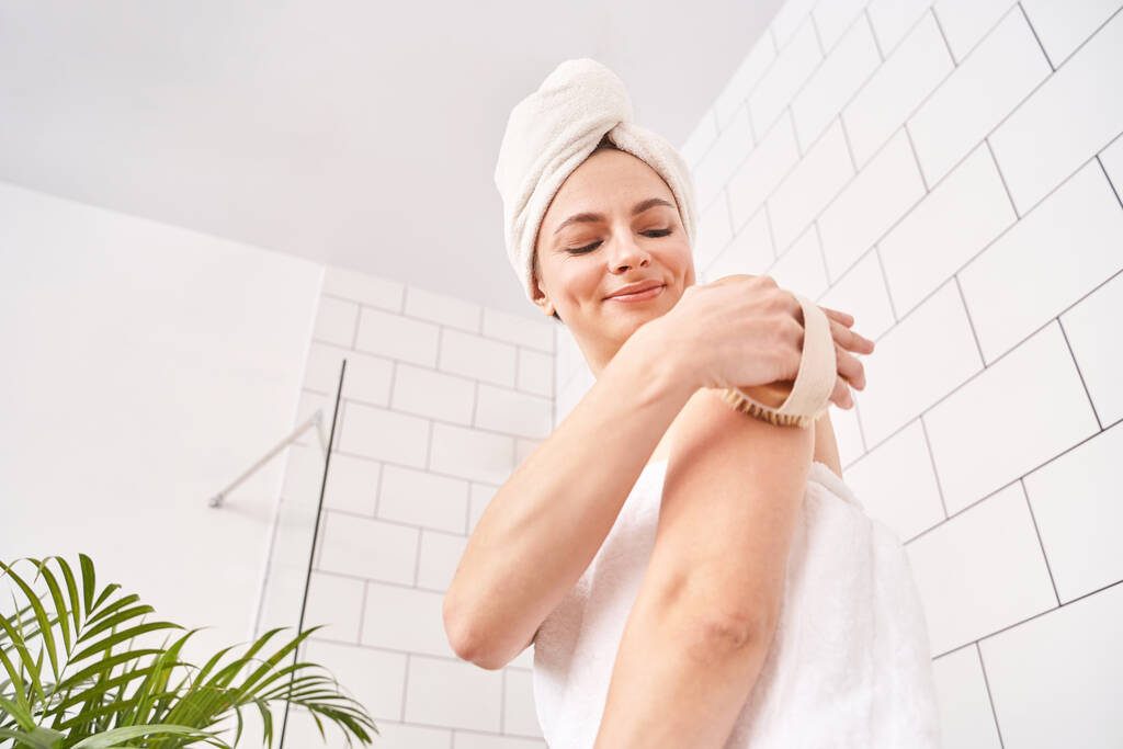 Badezimmer Hautpflege. Körperbürste Routine. Frau schält sich. Weibliche Personenentwässerung - Foto, Bild