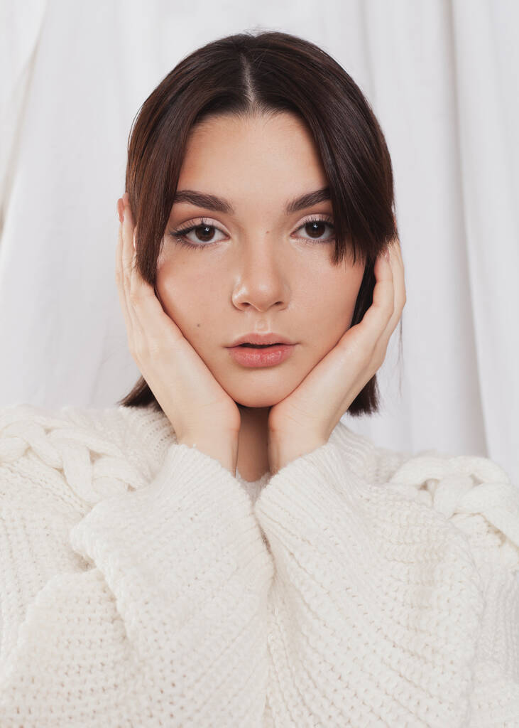 gentle portrait of a girl in a light sweater - Fotó, kép