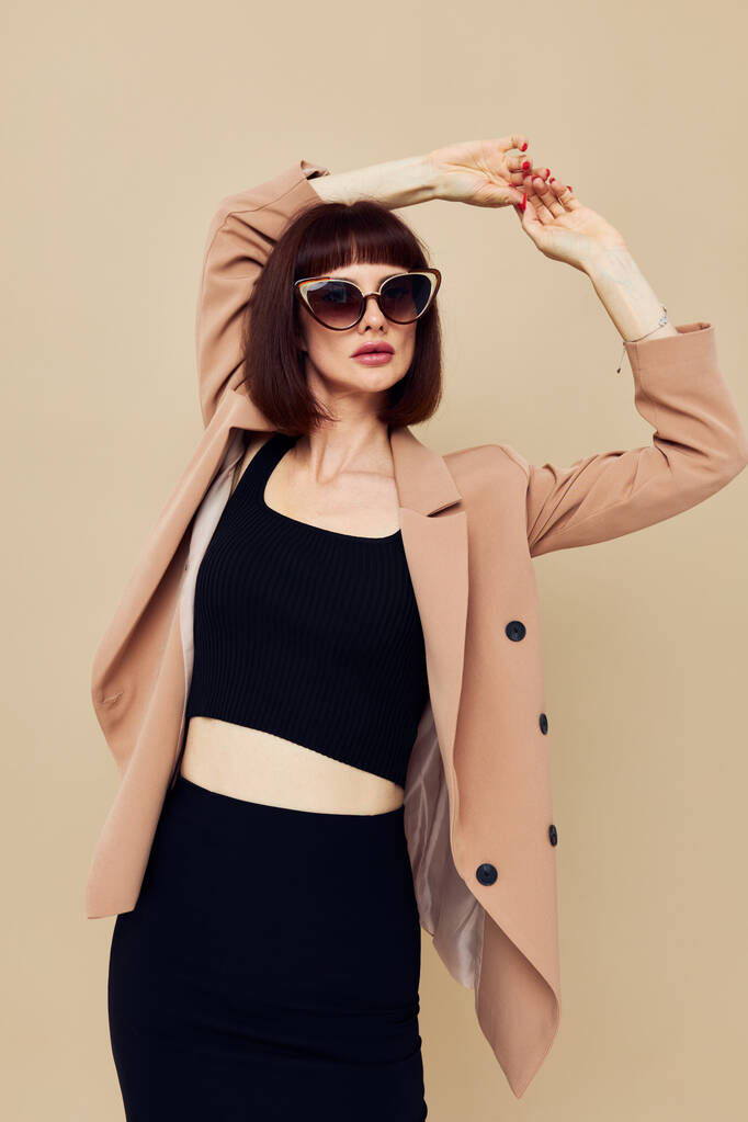 beautiful woman in sunglasses short haired suit gesturing with hands isolated background - Φωτογραφία, εικόνα