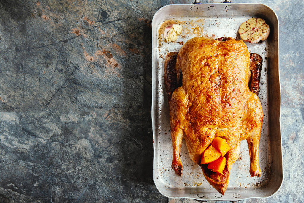 Baked roasted duck with vegetables on pan on stone background. Top View.  - Foto, Bild