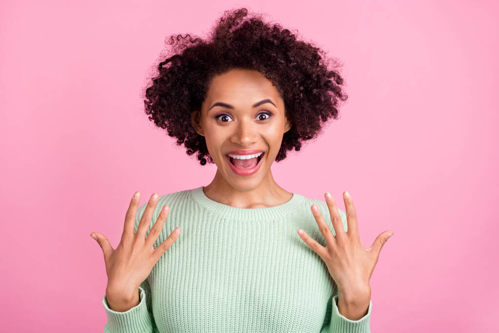 Photo of young happy dark skin amazed woman raise hands news shocked isolated on pink color background - Photo, Image
