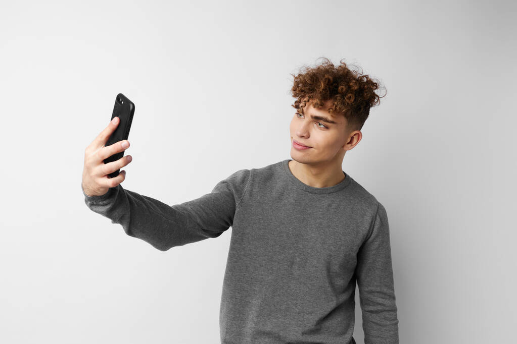 kinky guy technology with phone selfie isolated background - Φωτογραφία, εικόνα