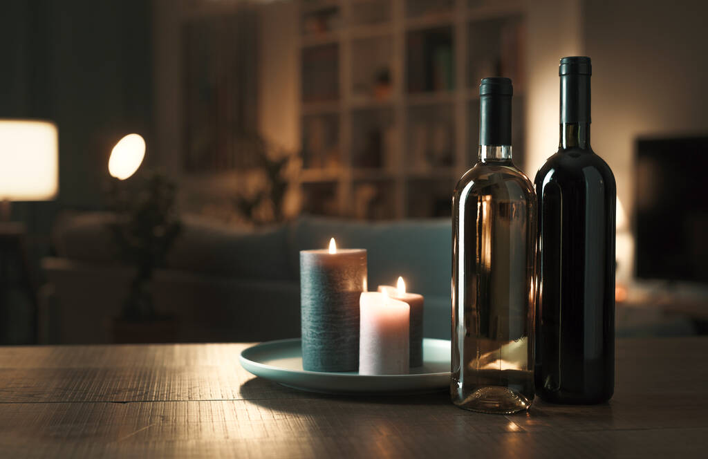 Garrafas de vinho tinto e branco de luxo em uma mesa na sala de estar em casa, conceito de degustação de vinhos - Foto, Imagem