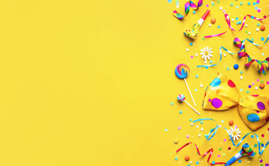 Colorful party items for carnival or birthday party on yellow background - Photo, Image