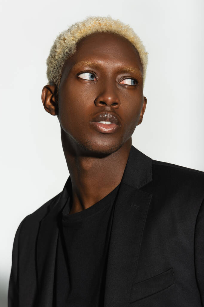 portré fiatal afro-amerikai férfi fehérített haj néz el elszigetelt szürke - Fotó, kép