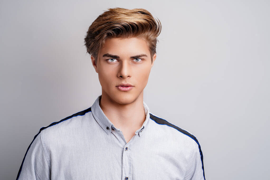 portrait of handsome young man wearing shirt while looking at camera. Stylish hairstyle.  - Photo, Image