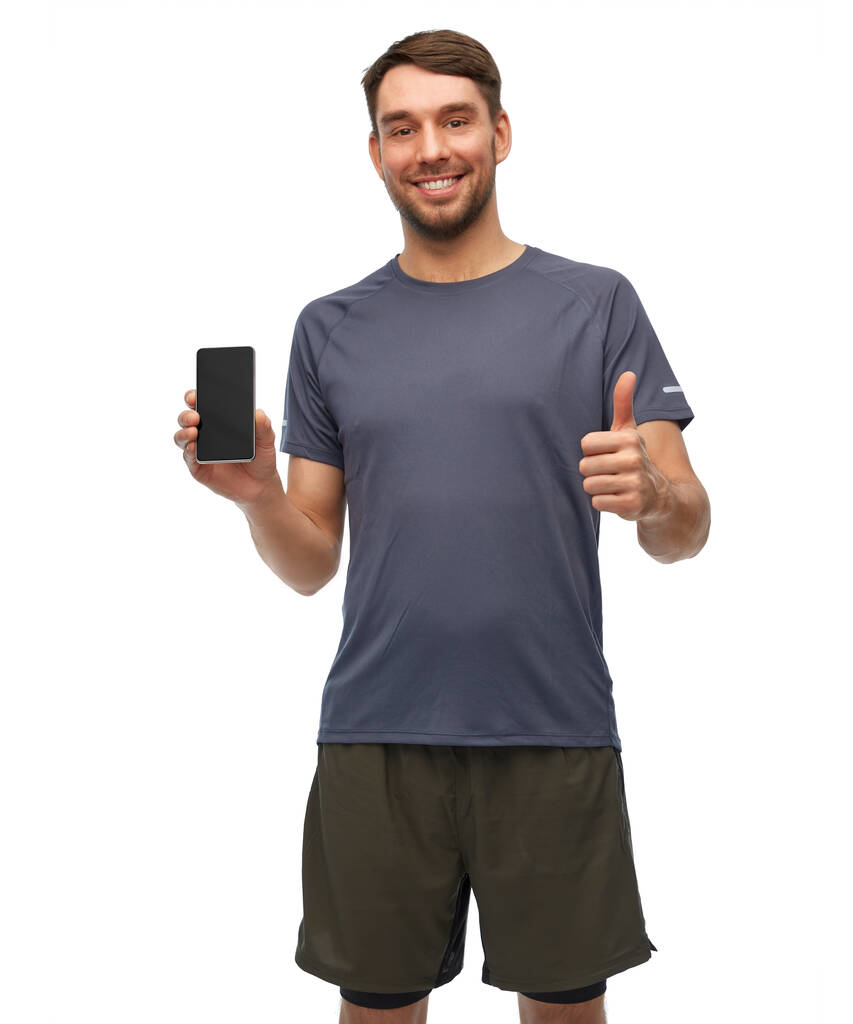 スマートフォンを見せてスポーツ服を着た笑顔の男 - 写真・画像