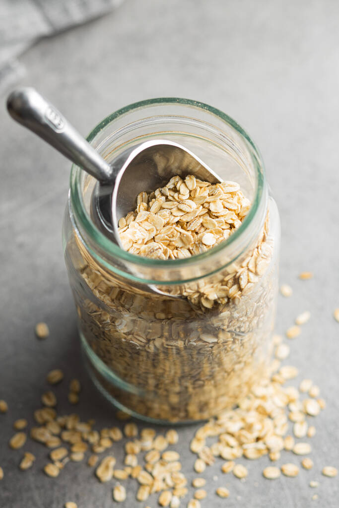 Breakfast cereals. Uncooked oatmeal. Raw oat flakes in jar. - Photo, Image