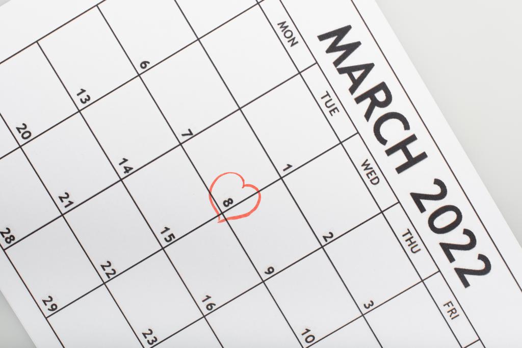top view of march 2022 calendar with drawn heart around 8 march date isolated on grey - Photo, Image