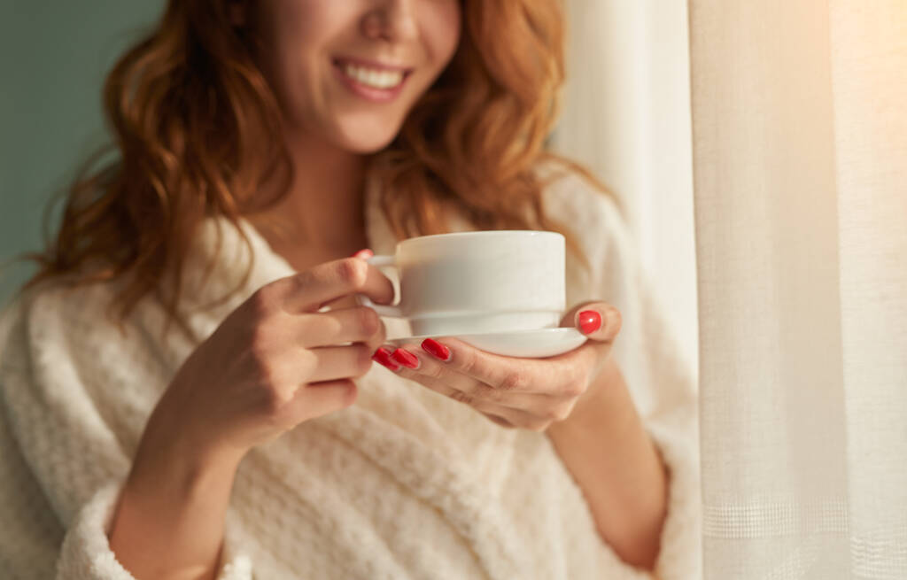 Περικοπή γυναίκα πίνοντας πρωινό καφέ στο σπίτι - Φωτογραφία, εικόνα