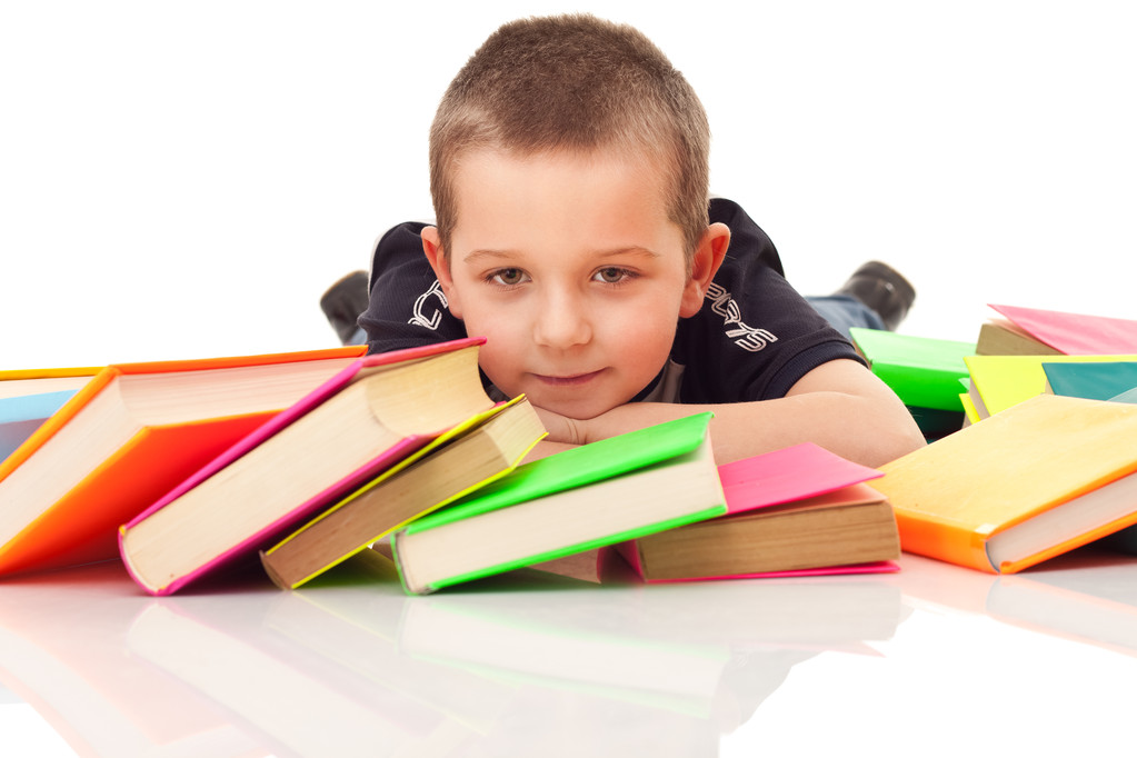 Niño con muchos libros tirados en el suelo
 - Foto, Imagen