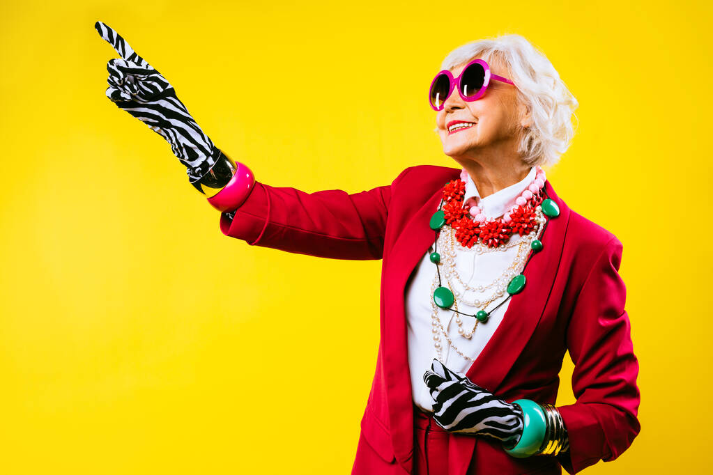Счастливая и смешная классная старушка с модным портретом одежды на цветном фоне - молодая бабушка с экстравагантным стилем, концепциями о стиле жизни, старшинстве и пожилых людях - Фото, изображение
