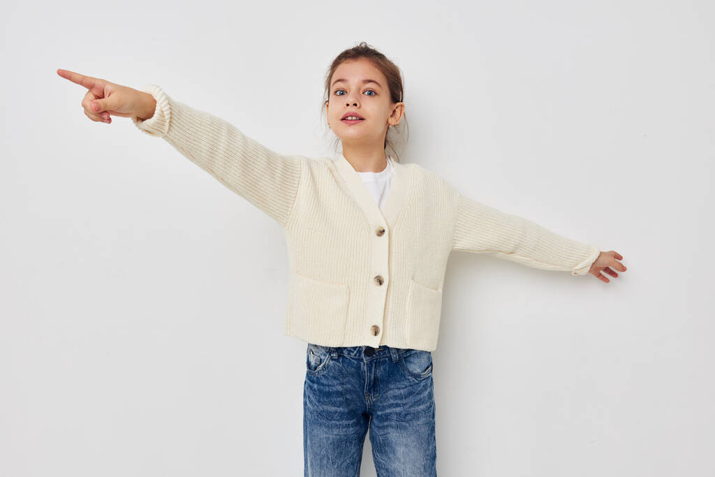 niña posando en un suéter blanco de la infancia inalterado - Foto, imagen