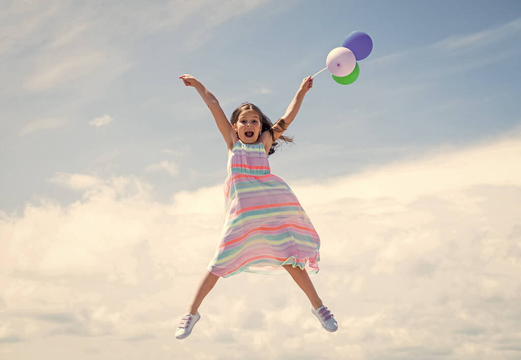 Loving her new style. feel free and joyful. smiling child jump with party balloons. childhood happiness. pretty teenage girl outdoor. kid summer fashion. happy birthday holiday. fashion and beauty - Photo, Image
