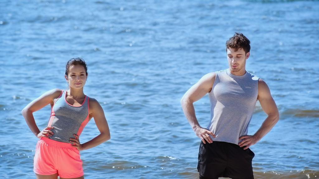 Young couple in sportswear training on beach  - Photo, Image