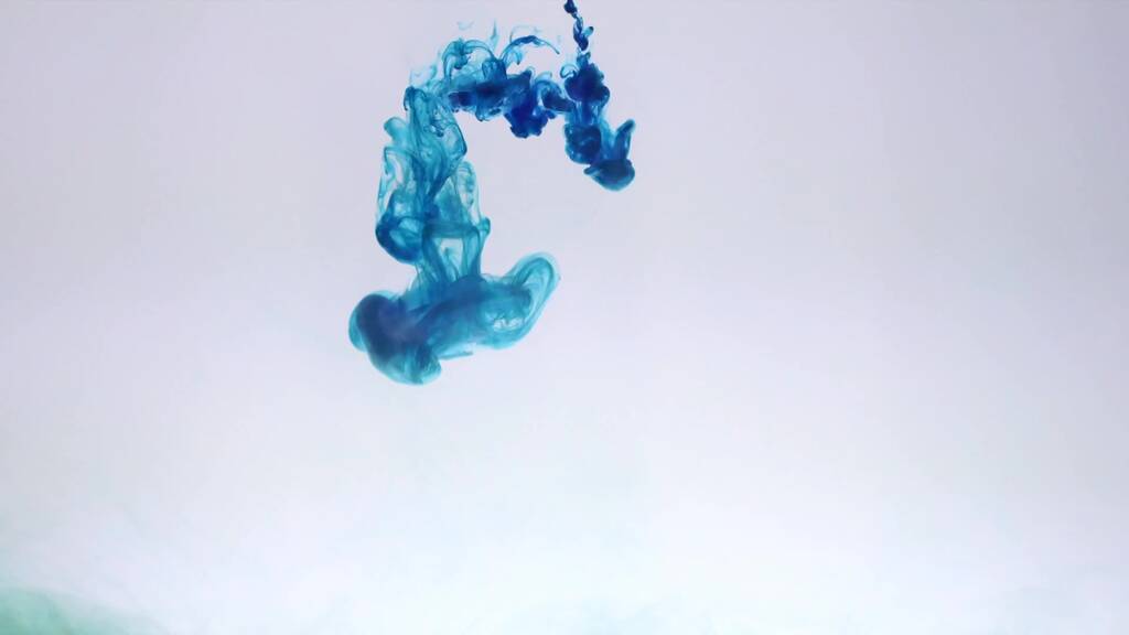 An explosion of colored paints in water on a white background - Photo, Image