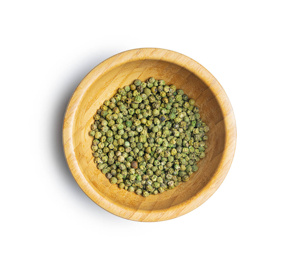 Dried green peppercorn. Dry green pepper spice in bowl isolated on a white table. - Photo, Image