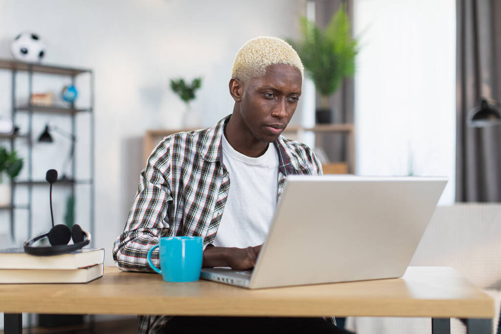 African american man working on laptop at home - Photo, Image