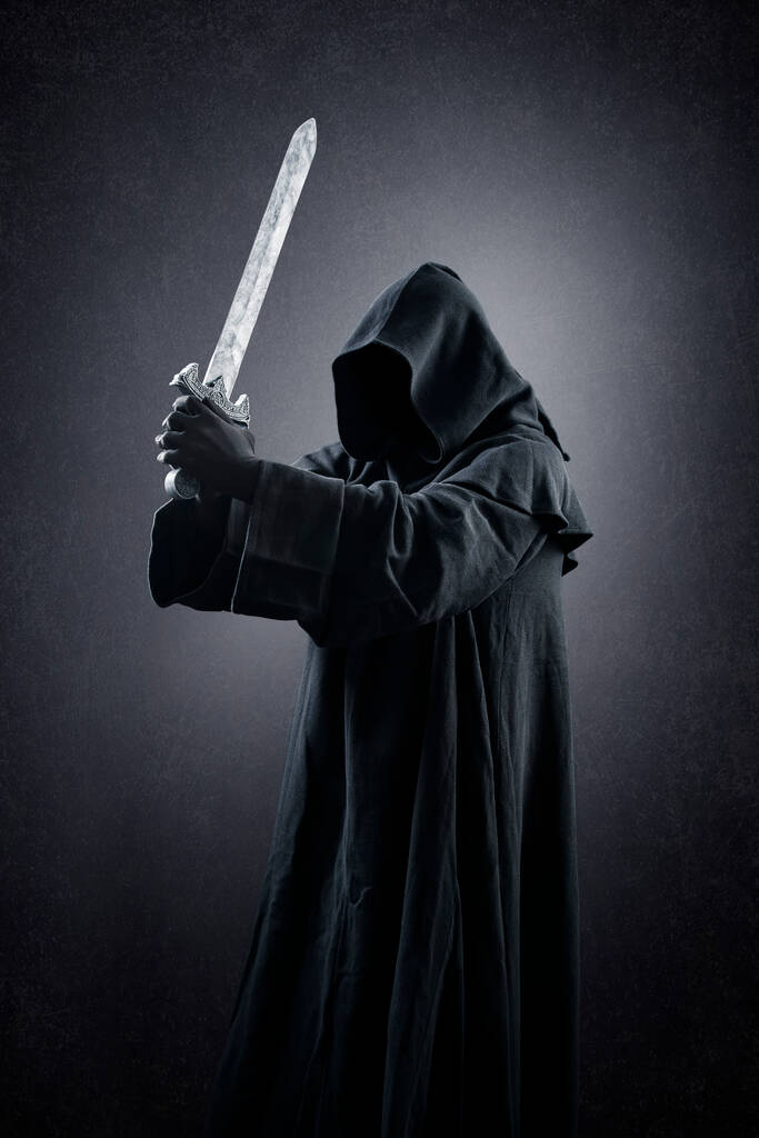 Πολεμιστής με κουκούλα κάπα και μεσαιωνικό σπαθί πάνω από σκοτεινό ομιχλώδες φόντο - Φωτογραφία, εικόνα