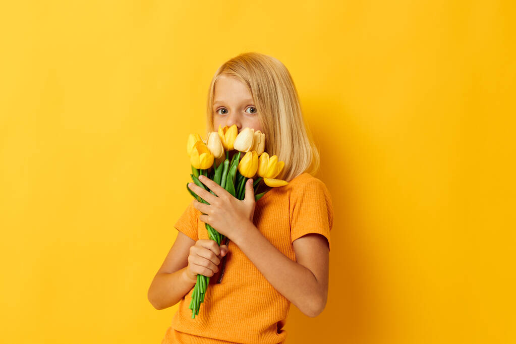 金髪の花の花束を持つ女の子子供の頃 - 写真・画像
