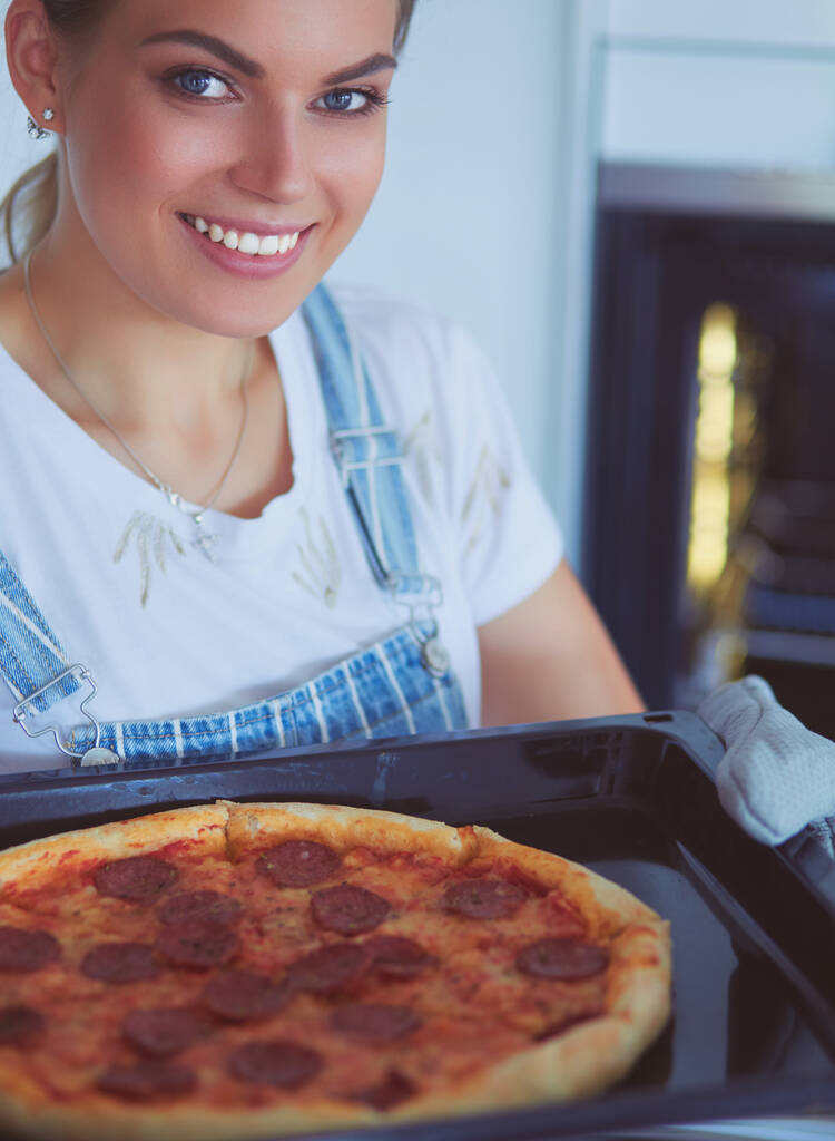 Jovem feliz cozinhar pizza em casa - Foto, Imagem
