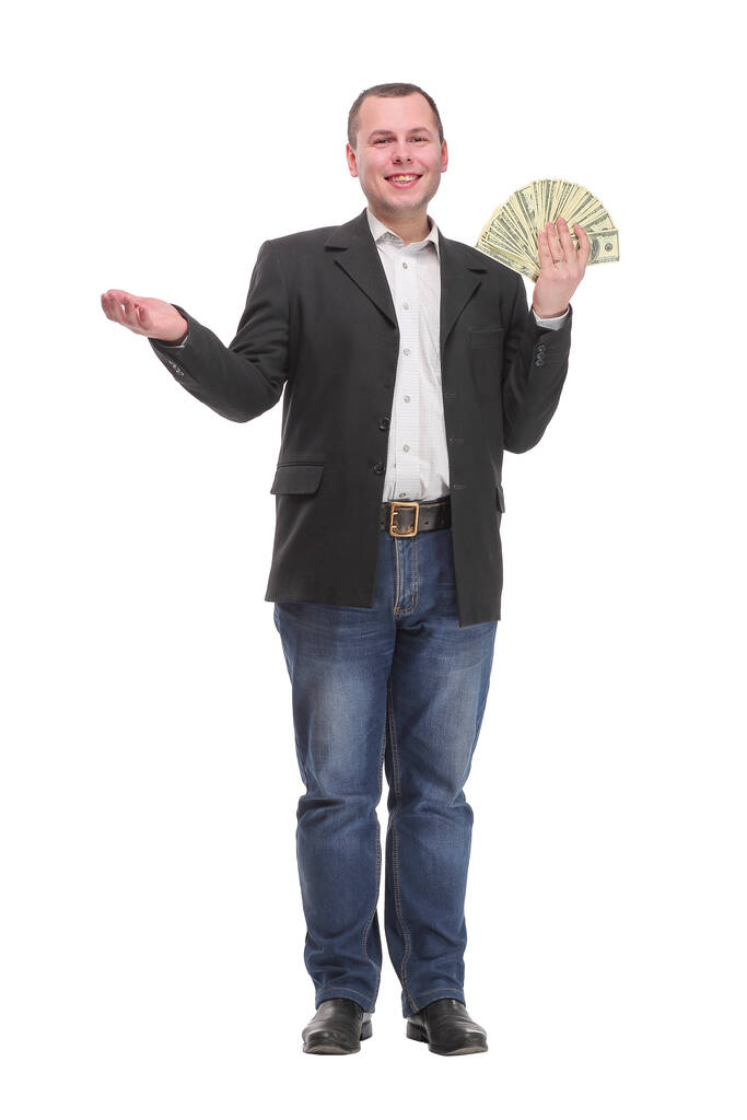 Portrait of smiling young man holding fanned US paper currency - Photo, Image
