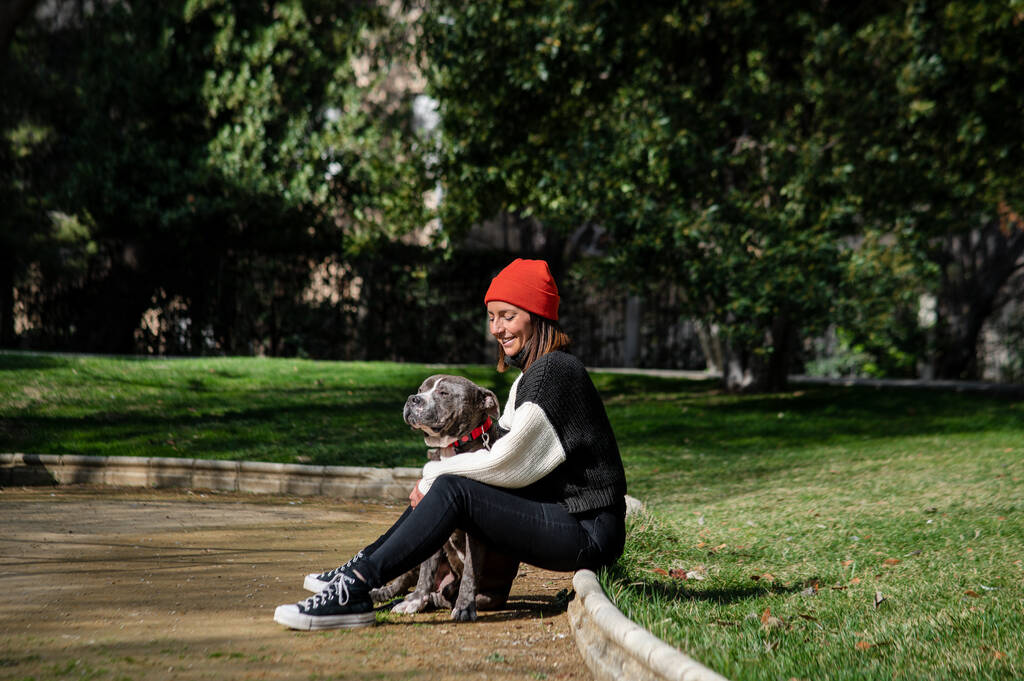 Chica joven con su perro en el parque en el verano - Foto, imagen