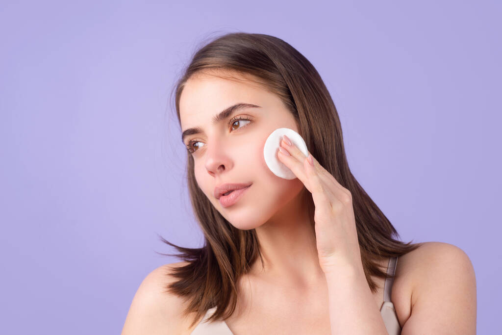 Beautiful woman with cotton pads, sponge, cotton ball. Skin care and beauty concept. Girl removes makeup with cotton ball from face. Skin care concept. Woman using cotton pad. - Photo, Image