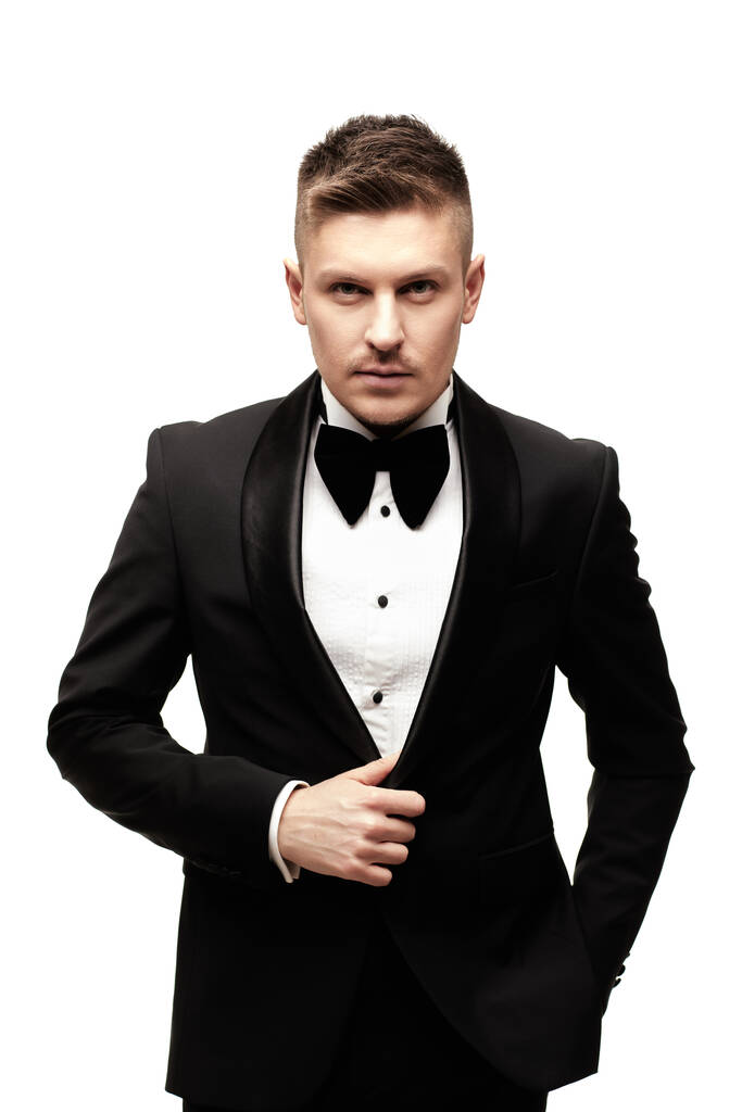 Confident attractive young man in black tuxedo - Photo, Image