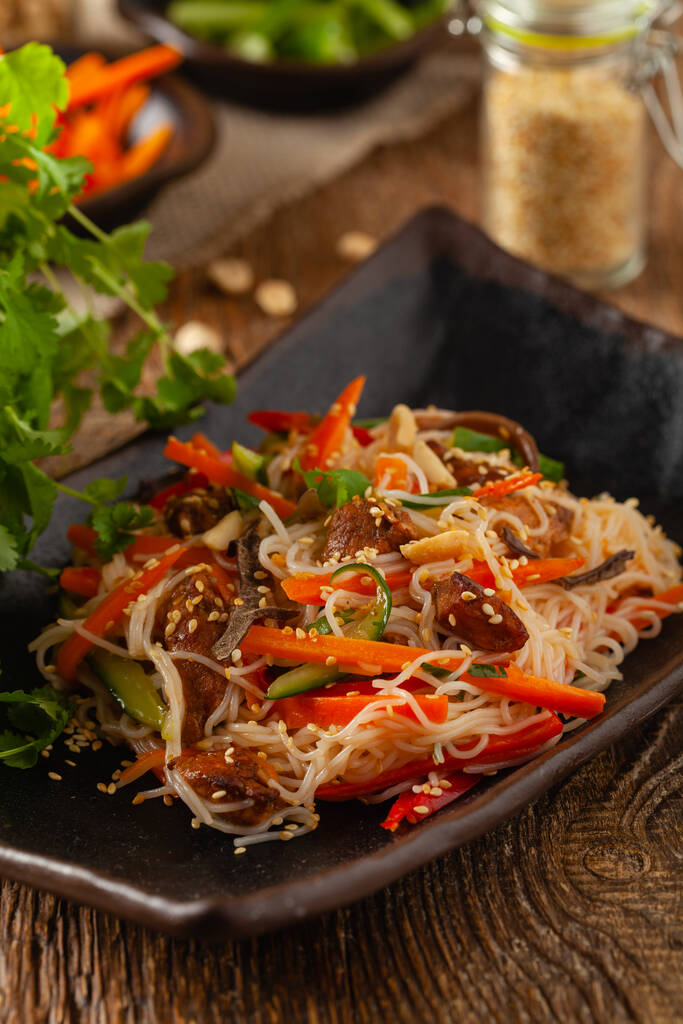 Oriental salad with rice noodles, chicken and mint. Front view. - Photo, Image