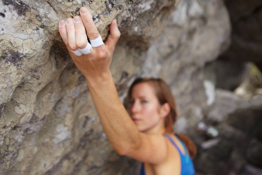 Strong fingers. A rock climber trying to get her grip. - Photo, Image