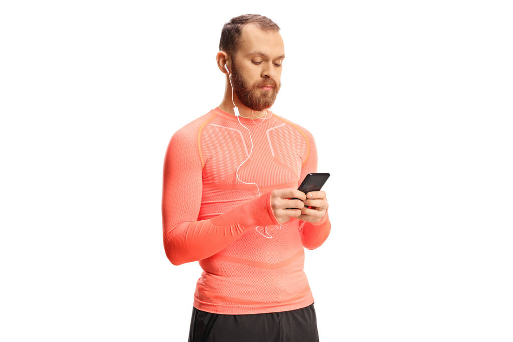 Corredor masculino com fones de ouvido segurando um smartphone isolado em fundo branco - Foto, Imagem
