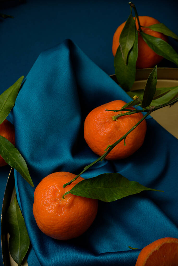 tangerines with leaves on a blue background. - Photo, Image