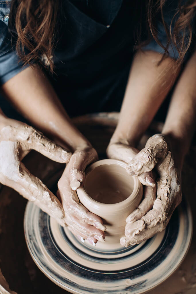 陶芸家は陶芸家の車輪にジャグを作る - 写真・画像