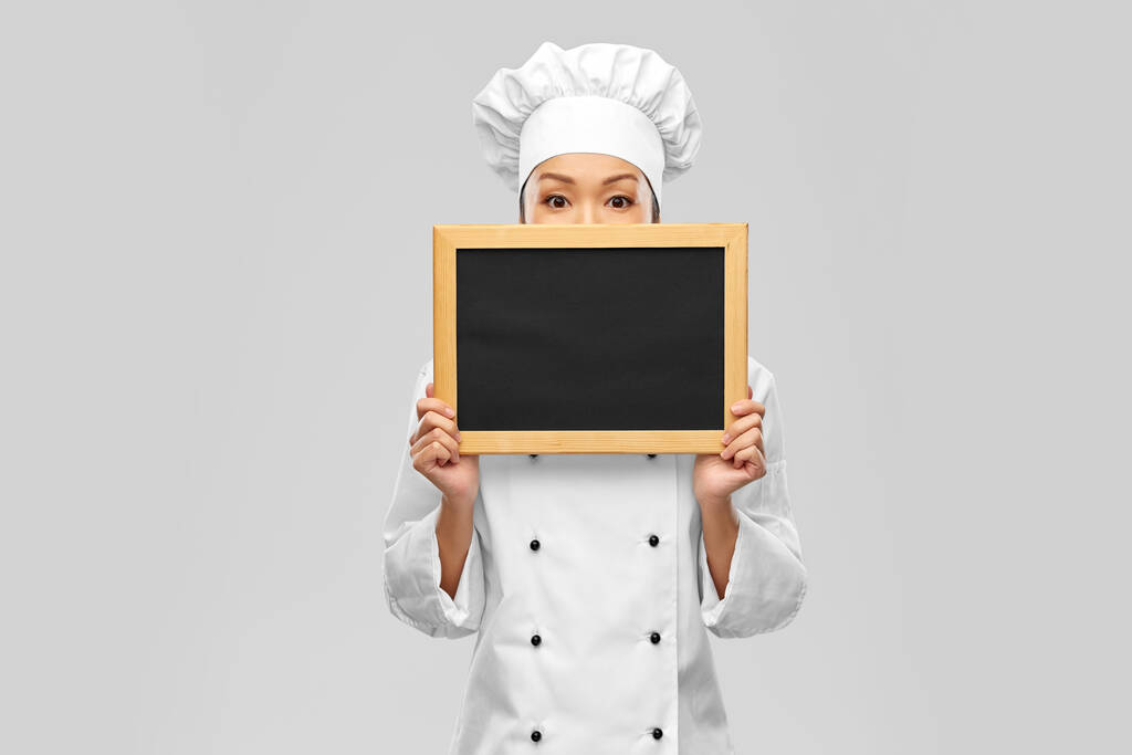 šéfkuchařka drží černou tabuli - Fotografie, Obrázek