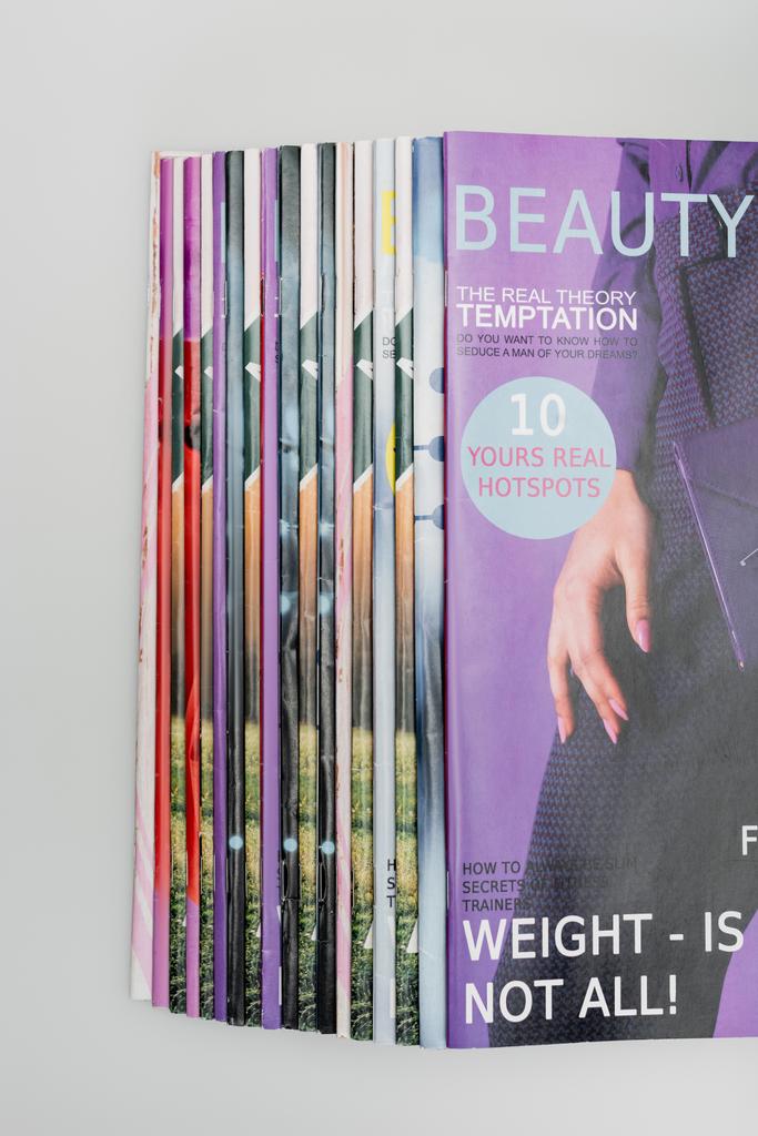 вид зверху журналів краси, складених ізольовано на сірому
 - Фото, зображення