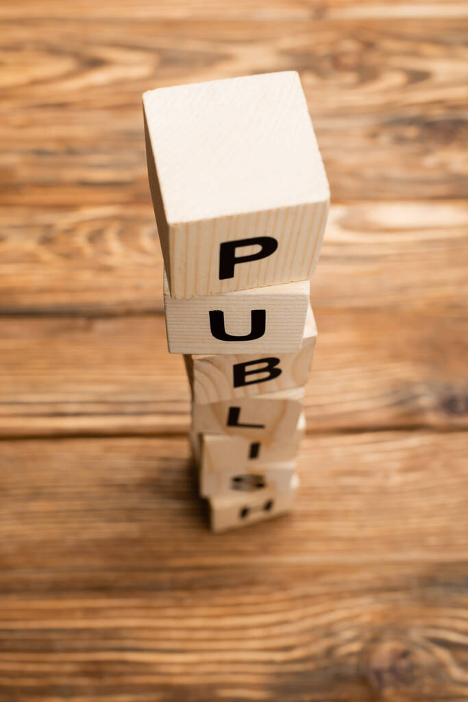 stacked cubes with word publish on blurred wooden surface - Photo, Image