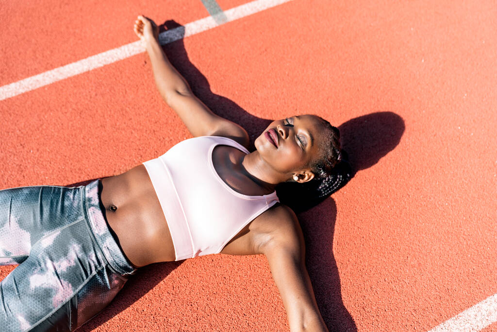 Athlete sprinter lying down on the floor - Photo, Image